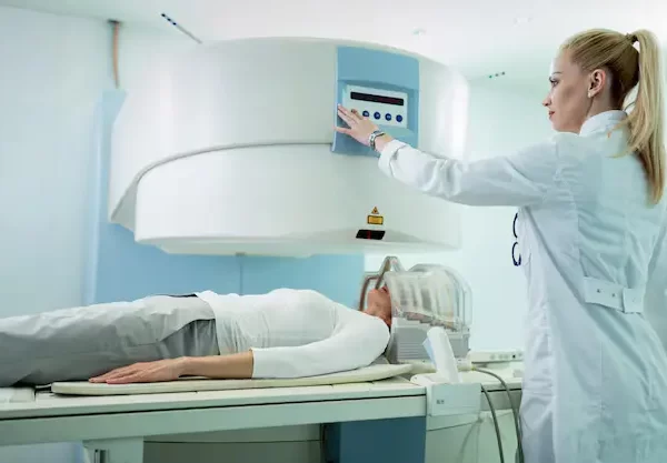 radiologist-adjusting-mri-scanner-before-medical-examination-patient-who-is-getting-brain-scan-hospital_637285-413-ezgif.com-avif-to-webp-converter MRI